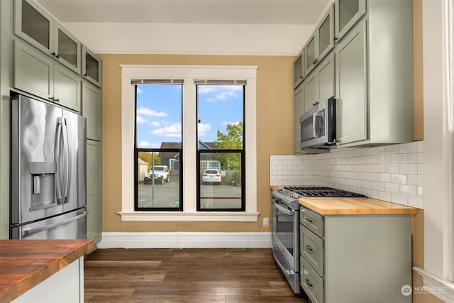 kitchen with wood counters, stainless steel appliances, dark hardwood / wood-style floors, and green cabinetry