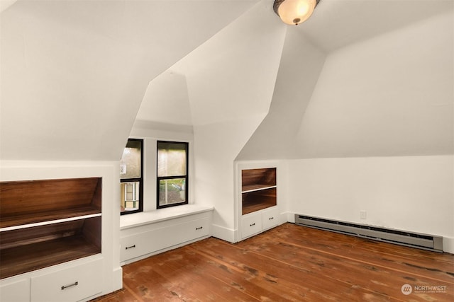 additional living space with hardwood / wood-style flooring, vaulted ceiling, and baseboard heating