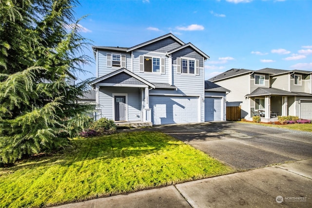 view of front property featuring a garage and a front lawn