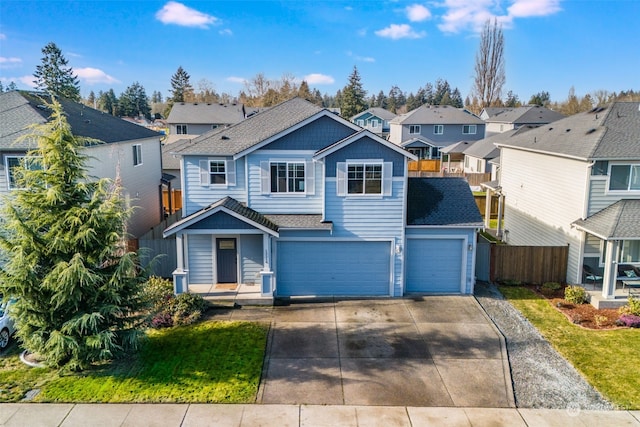 view of front of property with a garage and a front lawn