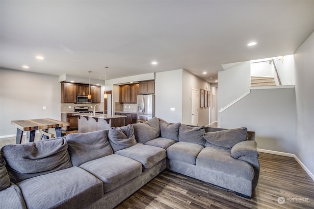 living room featuring dark hardwood / wood-style floors and sink