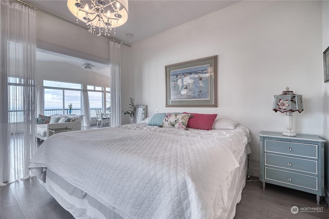 bedroom featuring a notable chandelier and dark hardwood / wood-style flooring