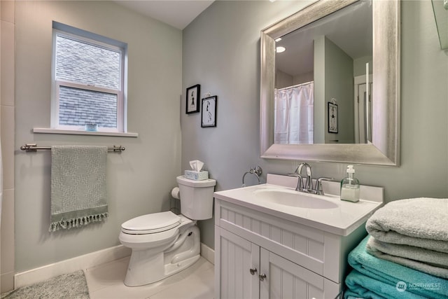 bathroom with vanity, tile patterned flooring, and toilet