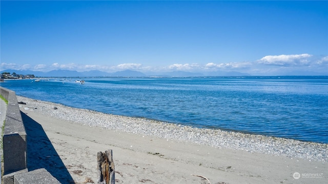 water view featuring a view of the beach and a mountain view