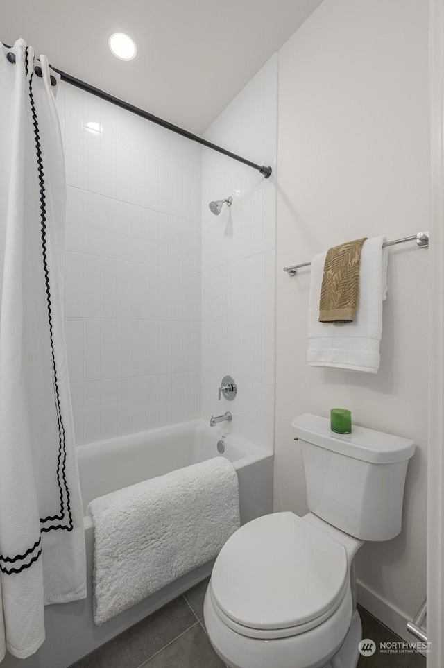 bathroom featuring tile patterned flooring, shower / bath combination with curtain, and toilet