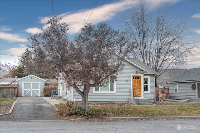 bungalow-style house with a storage shed and central AC unit