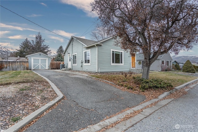 view of front of property with a storage shed