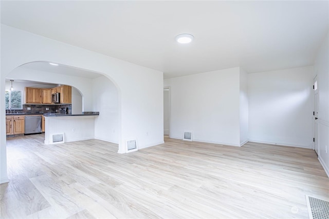 unfurnished living room with light wood-type flooring