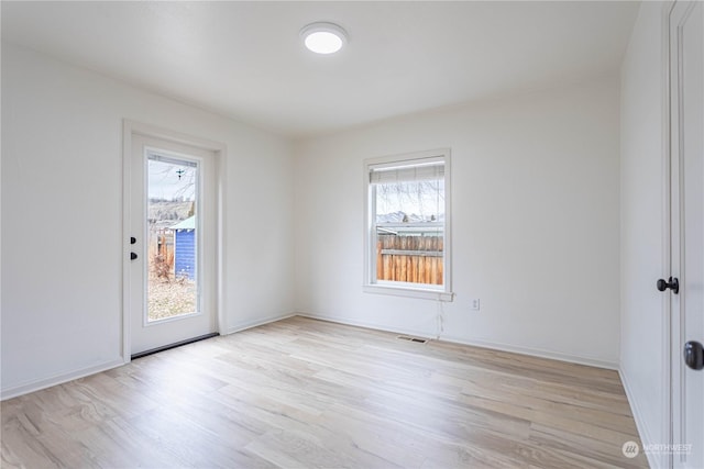 spare room with light wood-type flooring