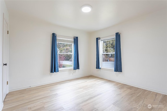 empty room featuring light hardwood / wood-style flooring and a wealth of natural light