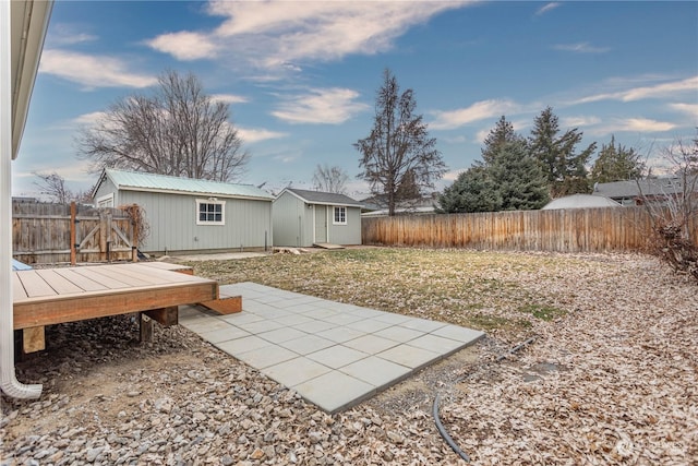 view of yard featuring a patio and a shed