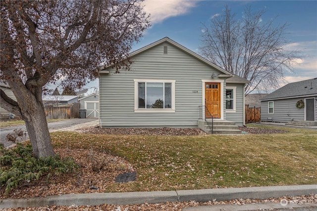 bungalow-style home featuring a yard