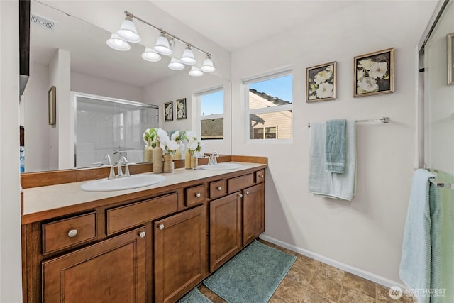 full bathroom featuring a stall shower, visible vents, a sink, and double vanity