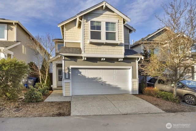 view of front facade featuring concrete driveway, roof with shingles, and an attached garage