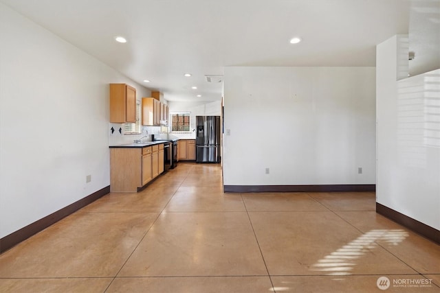 kitchen with black dishwasher, sink, and refrigerator with ice dispenser