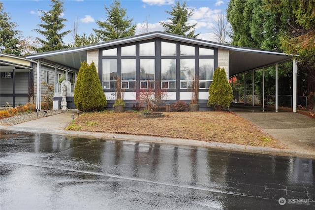 view of front of home featuring a carport and a sunroom