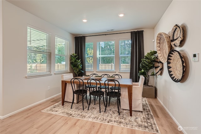 dining space with light hardwood / wood-style flooring