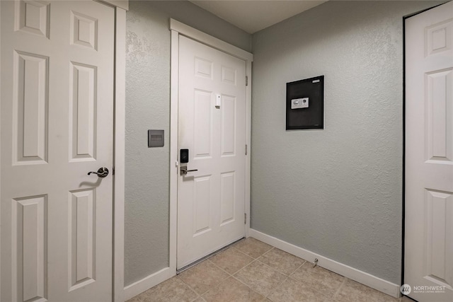 entryway featuring light tile patterned flooring