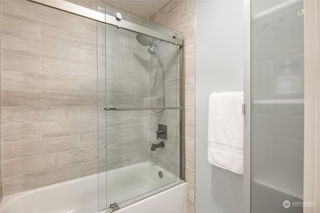 bathroom with shower / bath combination with glass door