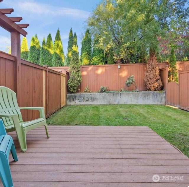 wooden deck featuring a yard