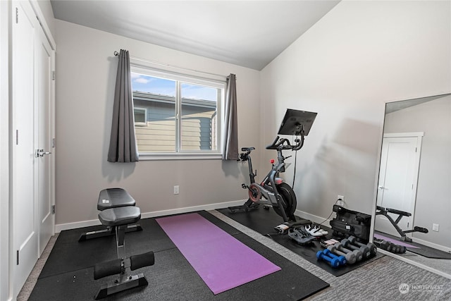 exercise room with vaulted ceiling