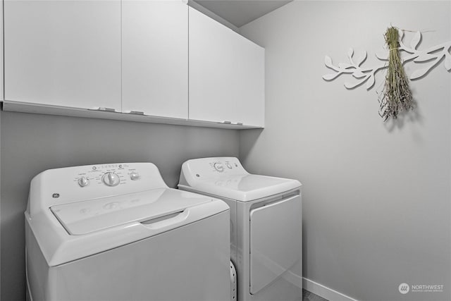 laundry room with cabinets and washer and clothes dryer