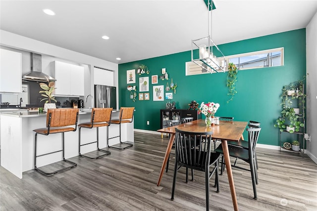 dining space featuring sink and hardwood / wood-style floors