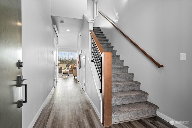 staircase with hardwood / wood-style floors