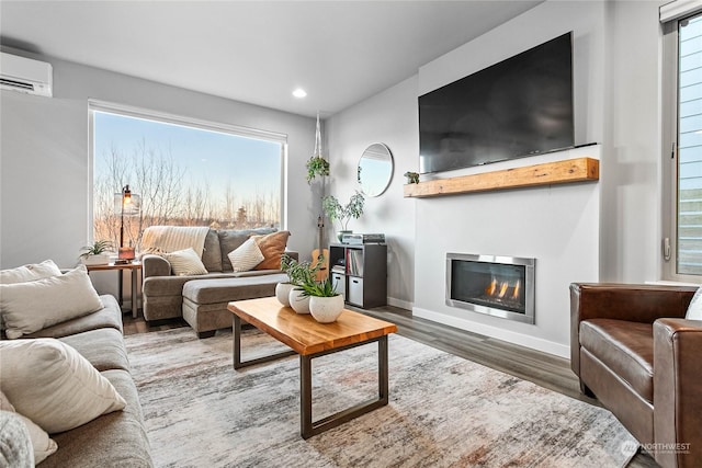 living room with hardwood / wood-style floors and a wall mounted AC