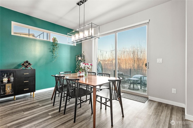 dining room featuring wood-type flooring and a chandelier