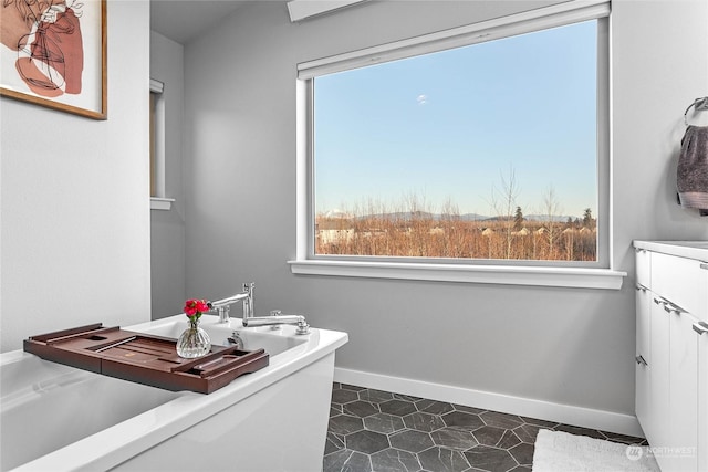 bathroom with vanity, a bath, and tile patterned flooring