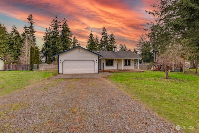 ranch-style house with a porch, a garage, and a lawn