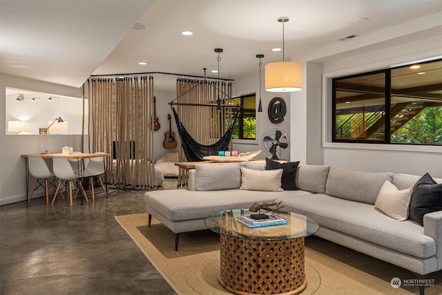 living room featuring concrete flooring