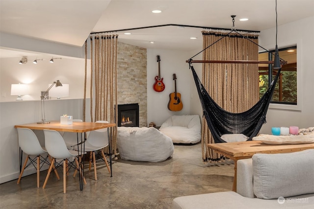 interior space with a stone fireplace and concrete flooring