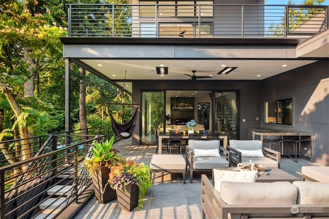 view of patio / terrace with ceiling fan, an outdoor hangout area, and a balcony