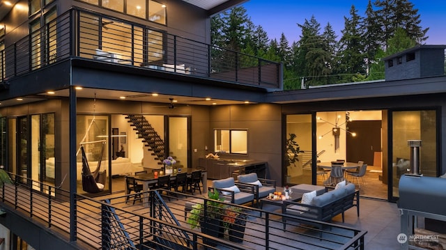 deck at dusk featuring a patio and outdoor lounge area