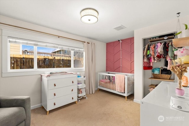 bedroom featuring light colored carpet and a closet