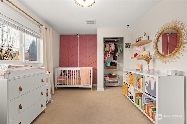 bedroom featuring a closet and light carpet