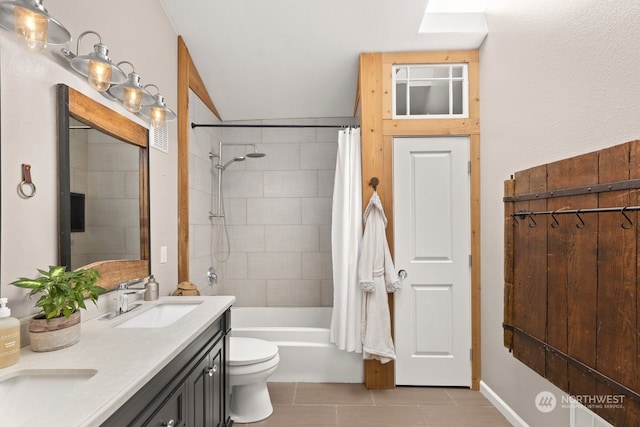 full bathroom featuring tile patterned floors, toilet, a skylight, vanity, and shower / bath combination with curtain