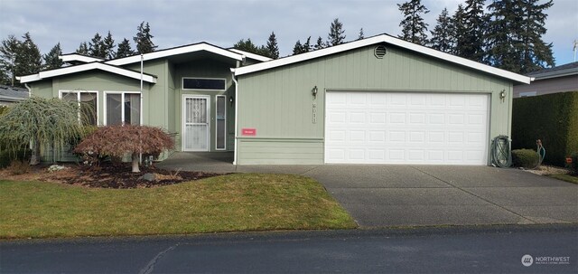 ranch-style home with a garage and a front lawn