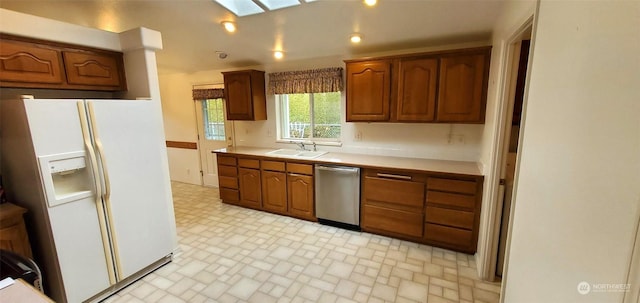 kitchen with dishwasher, sink, and white fridge with ice dispenser