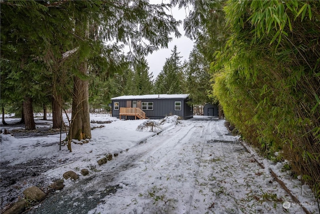 exterior space featuring a shed and a wooden deck