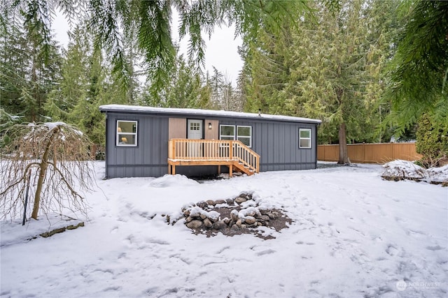 snow covered property featuring a deck