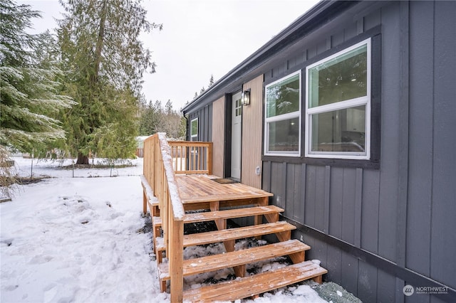 snow covered property with a wooden deck