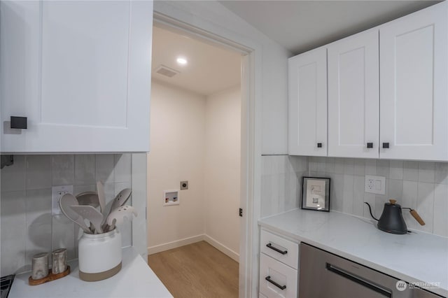 laundry area featuring cabinets, hookup for an electric dryer, hookup for a washing machine, and light hardwood / wood-style flooring