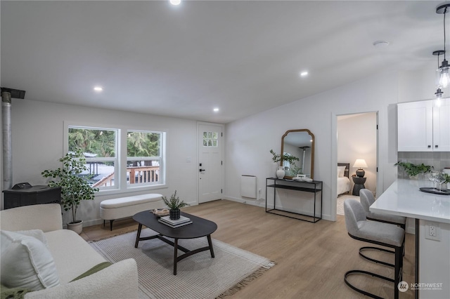 living room with vaulted ceiling and light hardwood / wood-style floors