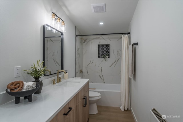 full bathroom featuring vanity, hardwood / wood-style flooring, toilet, and shower / bathtub combination with curtain