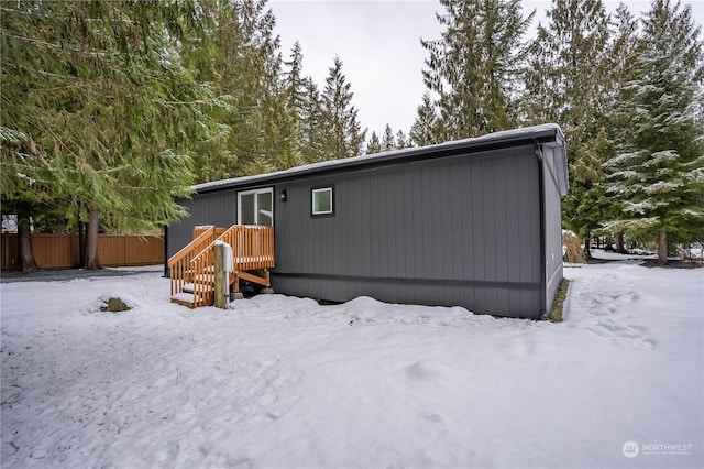 view of snow covered rear of property