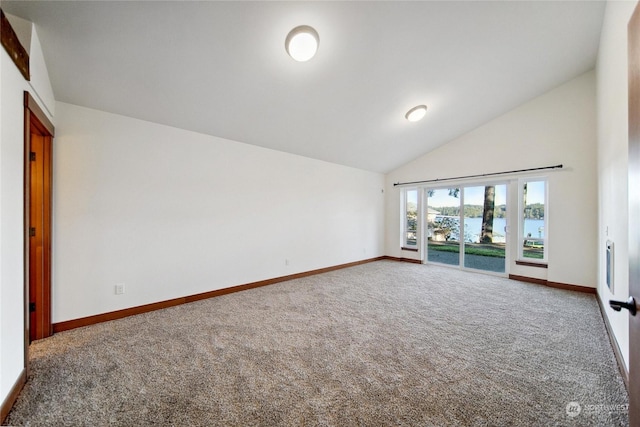 carpeted spare room with a water view and high vaulted ceiling