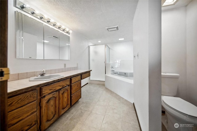 full bathroom featuring tile patterned flooring, vanity, a textured ceiling, independent shower and bath, and toilet